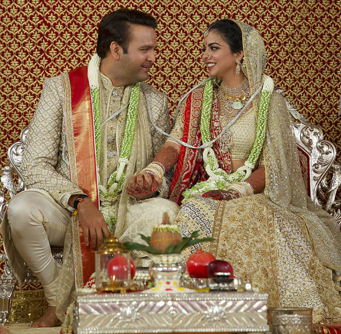 The happy couple: Isha Ambani and Anand Piramal tied the knot in front of a star-studded crowd at the Mumbai home of the fathers bride, Mukesh Ambani, 61, who has an estimated fortune of $41.5 billion (£33.1 billion)